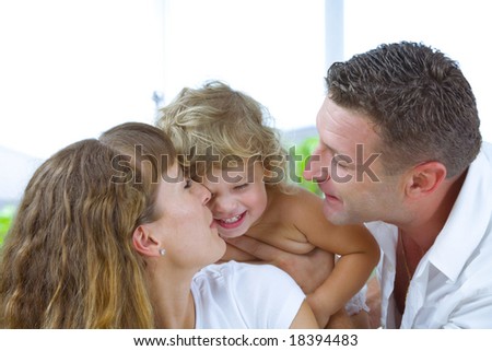 High key portrait of nice young family getting busy
