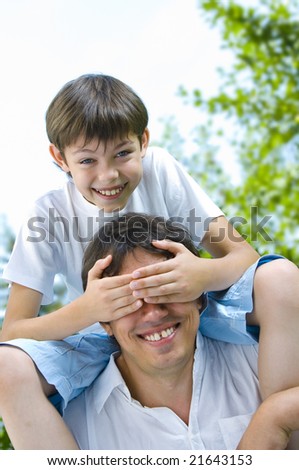 Portrait of young happy father getting  busy with his son