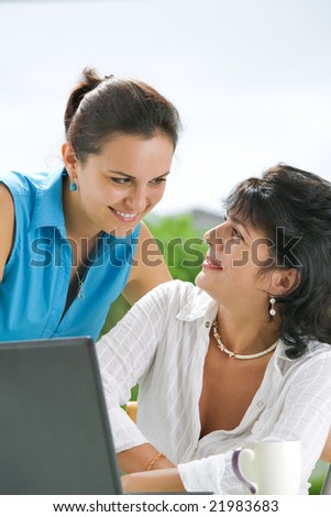 Portrait of  two women  getting busy with  laptop