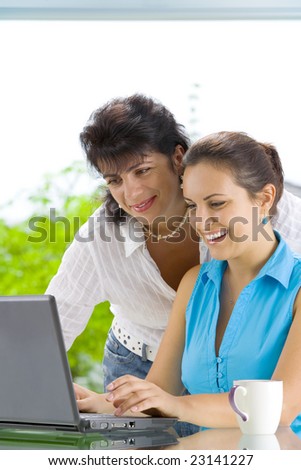 Portrait of  two women  getting busy with  laptop