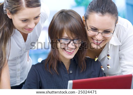 Portrait of young pretty women discussing project in office environment