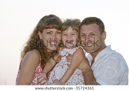 Portrait of young family having fun on white back