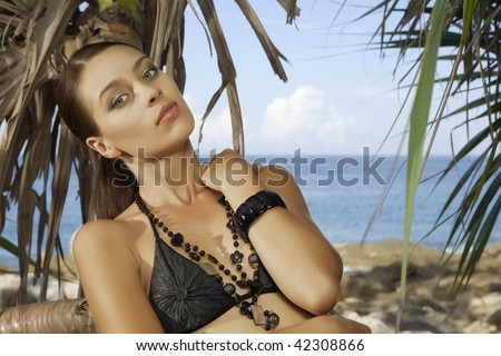 Portrait of young beautiful woman getting through the jungle