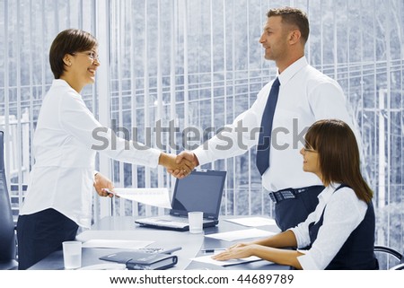 Portrait of young business people  discussing project in office environment