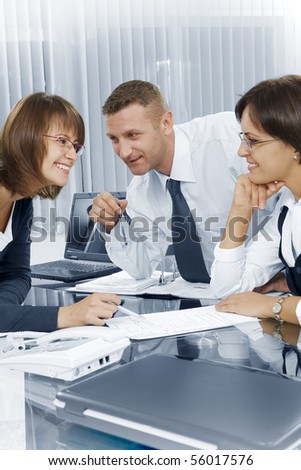 Portrait of young business people  discussing project in office environment