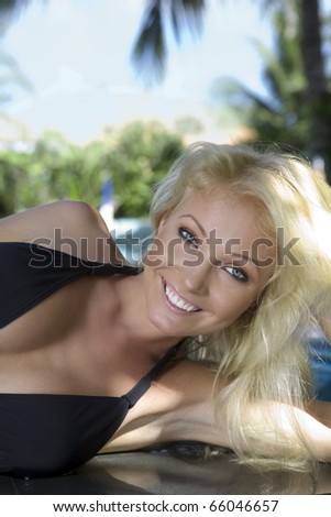 Portrait of young attractive woman having good time swimming pool