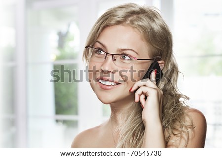 high key portrait of young woman with mobile phone