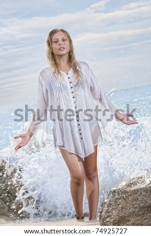 portrait of young beautiful woman  is being  splashed on color  back