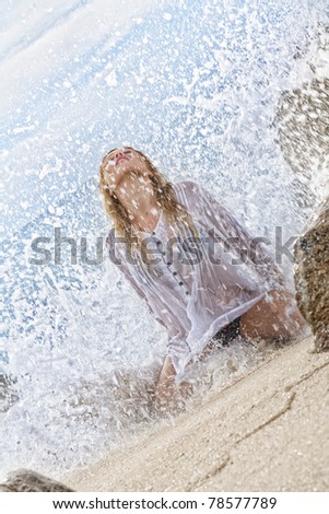 portrait of young beautiful water splashed  woman  on color  back