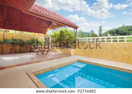 panoramic view of nice summer house patio with swimming pool