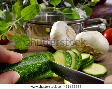 zucchini and garlic in front of a cooking pot