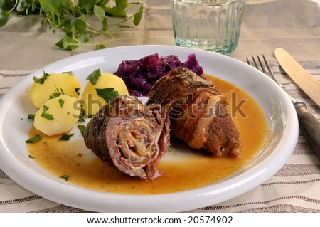 roulade with red cabbage and potatoes on a plate