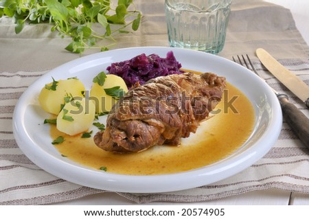 roulade with red cabbage and potatoes on a plate
