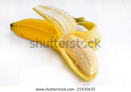 Closeup from a single open bananas on a white table