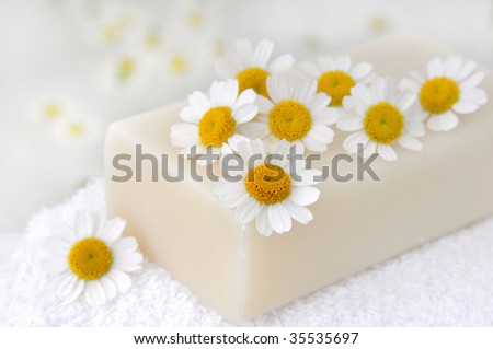 Soap with camomile flowers in the bath