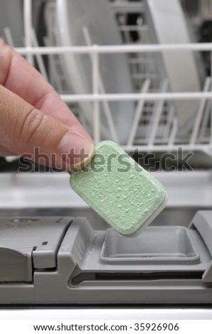 Put a detergent tab into a dishwasher