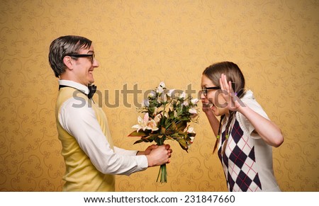 Male nerd giving flowers to female nerd