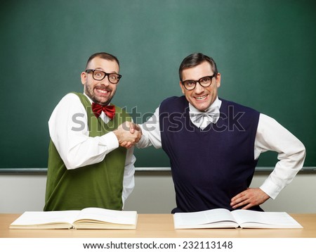 Two male nerds shaking hands