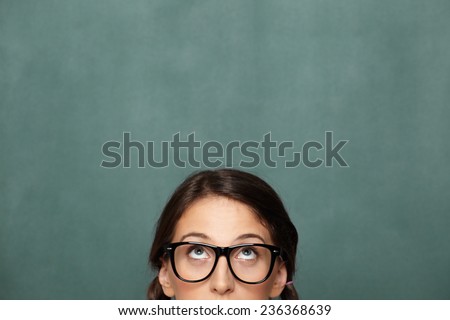Portrait of young female nerd looking up