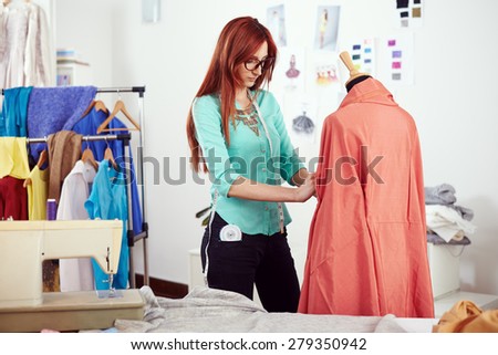 Designer measuring dress