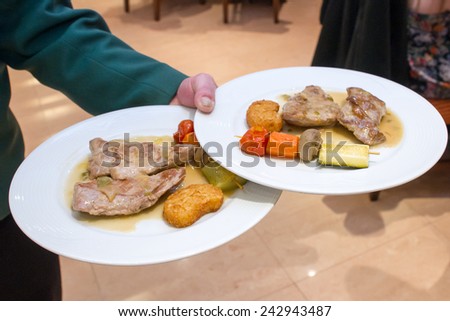 Hot meat and vegetable snack. The waiter takes