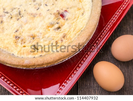 Quiche a savory, open-faced pastry crust dish with a filling of savory custard with cheese, meat or vegetables