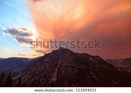 Smoke filled sunset skies over the Beartooth Mountains of Montana from wildfire forest fires.