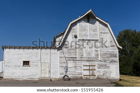 An old white panted hay barn on a ranch in Montana.