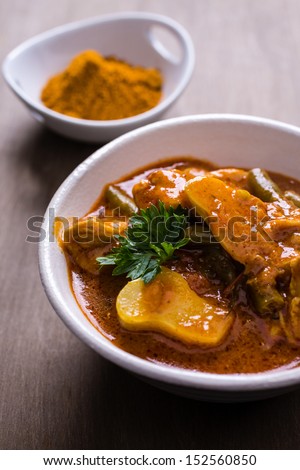Creamy tomato, lemon, cilantro and spices tikka masala curry with curry powder.