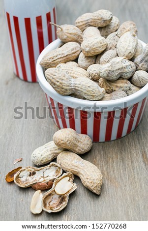 A snack bowl full of fresh roasted peanuts in the shell.