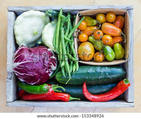 Wooden box full of fresh veggies.