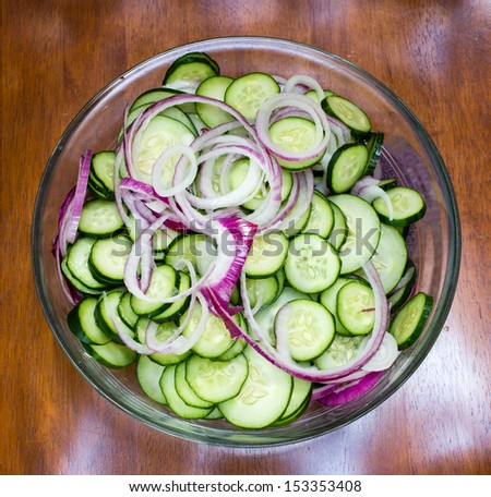 Cucumbers and onions sliced into chips for pickle making.