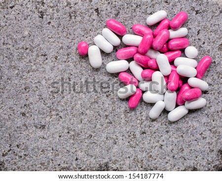 Candy covered licorice over granite background with copy space.