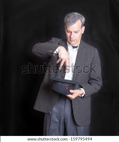 A magician performing a trick on stage at a magic show.