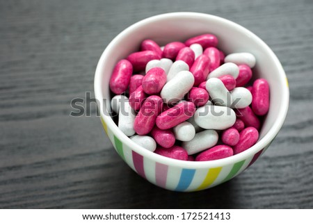A candy bowl filled with colorful candies.