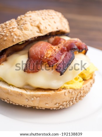Breakfast sandwich on a bagel with bacon, egg and cheese.