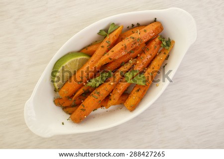 A dish of coriander roasted carrots with olive oil and lime juice.