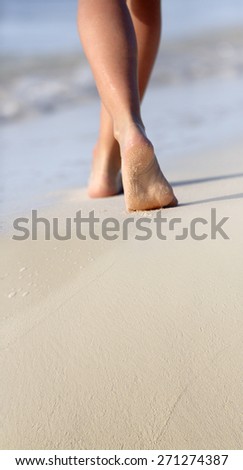 Young  Woman\'s Legs  Walking  Along Beach