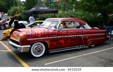 A classic car displayed at a street antique car show - 1953 Mercury