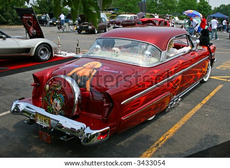 A classic car displayed at a street antique car show - 1953 Mercury