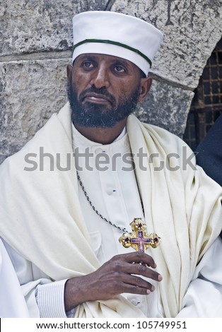 JERUSALEM - APRIL 14 : Ethiopian Orthodox priest await the start of the Holy fire ceremony at the Ethiopian section of the Holy Sepulcher in Jerusalm Israel on April 14 2012