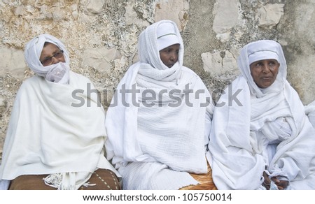 JERUSALEM - APRIL 14 : Ethiopian Orthodox worshipers await the start of the Holy fire ceremony at the Ethiopian section of the Holy Sepulcher in Jerusalm Israel on April 14 2012