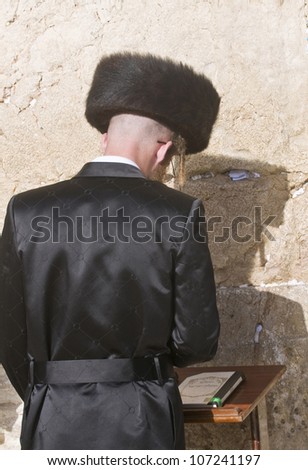JERUSALEM - APRIL 08 : Orthodox jewish man prays in The western wall during Passover on April 08 2012 , The Western wall is important Jewish religious site located in the Old City of Jerusalem