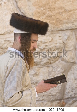 JERUSALEM - APRIL 08 : Orthodox jewish men prays in The western wall during Passover on April 08 2012 , The Western wall is important Jewish religious site located in the Old City of Jerusalem