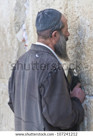 JERUSALEM - FEB 05 : Orthodox jewish man prays in The western wall on February 05 2011 , The Western wall is important Jewish religious site located in the Old City of Jerusalem , Israel