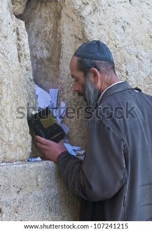 JERUSALEM - FEB 05 : Orthodox jewish man prays in The western wall on February 05 2011 , The Western wall is important Jewish religious site located in the Old City of Jerusalem , Israel