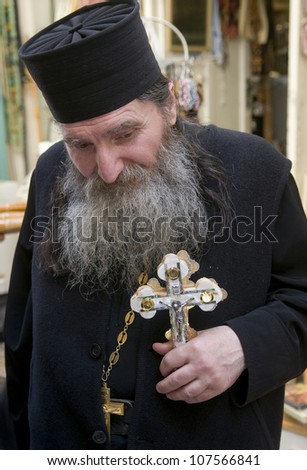 JERUSALEM - APRIL 13 : Russian Orthodox monk carry across along the Via Dolorosa in Jerusalem on April 13 2012 commemorating the path Jesus carried his cross on the day of his crucifixion