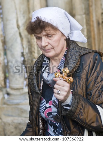 JERUSALEM - APRIL 13 : Christian pilgrim carry across along the Via Dolorosa in Jerusalem on April 13 2012 commemorating the path Jesus carried his cross on the day of his crucifixion