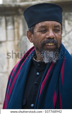 JERUSALEM - APRIL 14 : Ethiopian Orthodox priest await the start of the Holy fire ceremony at the Ethiopian section of the Holy Sepulcher in Jerusalm Israel on April 14 2012