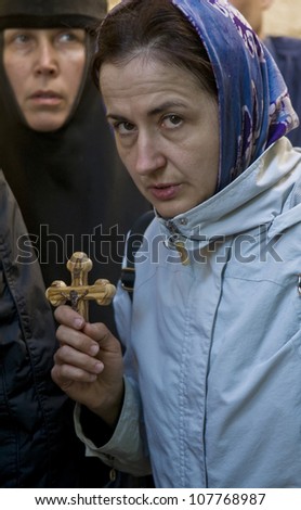 JERUSALEM - APRIL 13 : Christian pilgrims carry across along the Via Dolorosa in Jerusalem on April 13 2012 commemorating the path Jesus carried his cross on the day of his crucifixion